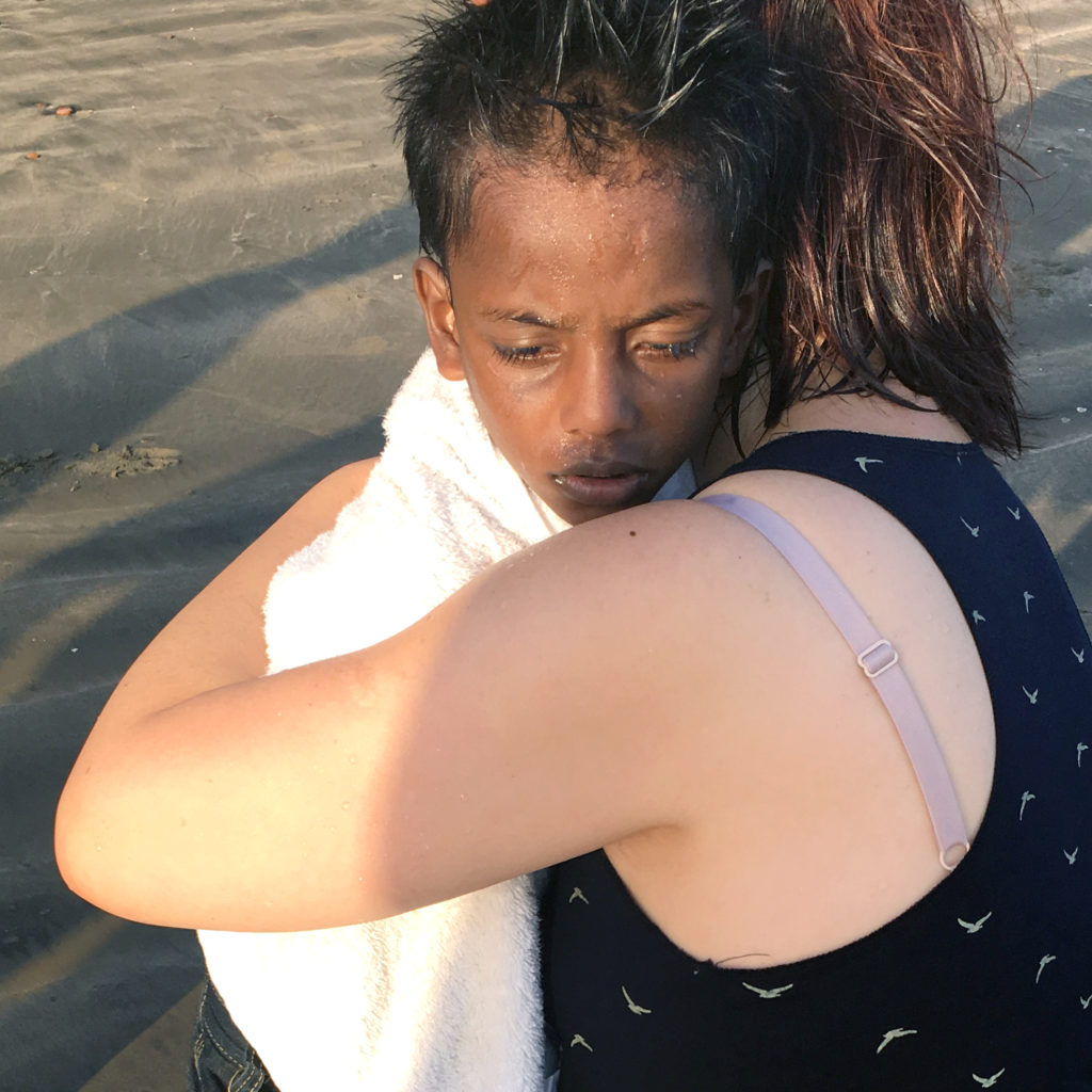 Boy from India being hugged