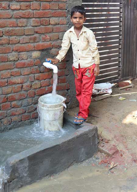 A child getting safe drinking water from a new bore