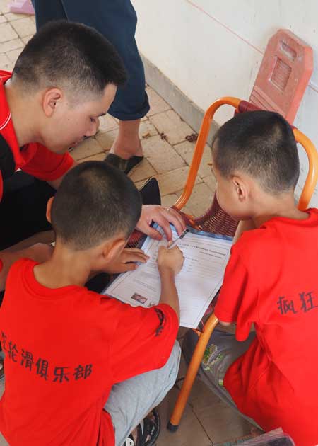 Two children and a co-worker writing a letter