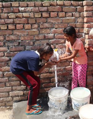 #LetsHelpOneMore children drinking from new water bore